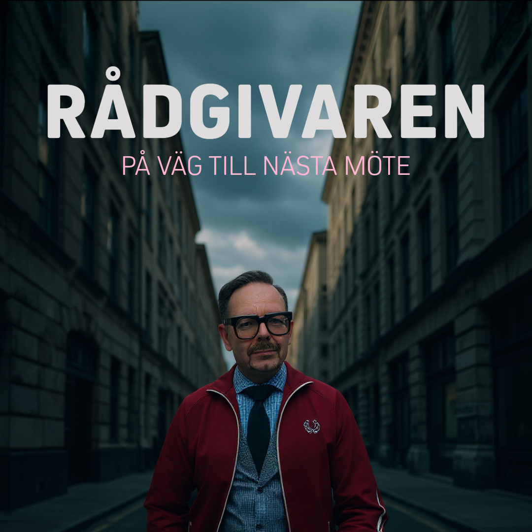 Man i glasögon och röd jacka står på en gata med byggnader i bakgrunden, på väg till nästa möte.